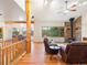 Spacious living room with a stone fireplace and dining area in an open floor plan at 28465 Cragmont Dr, Evergreen, CO 80439