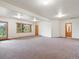 Spacious living room with carpet, a wooden door to the outside, and a window at 28465 Cragmont Dr, Evergreen, CO 80439