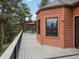 Spacious outdoor deck with views of surrounding trees and patio furniture at 28465 Cragmont Dr, Evergreen, CO 80439