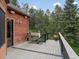 The outdoor deck has wooden planks and overlooks the forested back yard at 28465 Cragmont Dr, Evergreen, CO 80439
