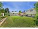 Generous backyard featuring a covered patio, well-kept lawn, shed, and a well-maintained exterior at 980 S Nile Way, Aurora, CO 80012