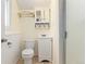 Cozy bathroom featuring a vanity with sink, toilet, and a tiled shower at 980 S Nile Way, Aurora, CO 80012