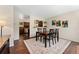 Open dining area with dark hardwood floors connecting to the kitchen, perfect for entertaining at 980 S Nile Way, Aurora, CO 80012