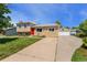 Charming home with a red front door, well-manicured lawn, and an inviting front entrance at 980 S Nile Way, Aurora, CO 80012