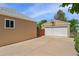 View of the detached, two-car garage with basketball hoop and concrete parking pad at 980 S Nile Way, Aurora, CO 80012