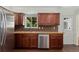 Charming kitchen featuring wood cabinetry, stainless steel appliances, and dark wood flooring at 980 S Nile Way, Aurora, CO 80012