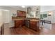 Functional kitchen with wooden cabinets, hardwood floors, modern range hood, and stainless steel appliances at 980 S Nile Way, Aurora, CO 80012
