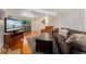 Basement living room featuring a TV, large sofa, and ample space for entertaining at 980 S Nile Way, Aurora, CO 80012