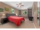 Comfortable main bedroom featuring a ceiling fan, large bed, and built-in shelving for storage and display at 980 S Nile Way, Aurora, CO 80012