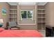 Main bedroom featuring built-in shelving, a window seat, and a cozy reading nook at 980 S Nile Way, Aurora, CO 80012