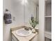 Compact bathroom featuring marble countertop, decorative plant, and towel ring, perfect for guests at 17681 E Loyola Dr # E, Aurora, CO 80013
