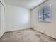 Neutral bedroom with a window allowing for natural light and a closet for storage at 17681 E Loyola Dr # E, Aurora, CO 80013