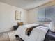 Comfortable bedroom featuring a plush bed, soft rug, and a window for natural light at 17681 E Loyola Dr # E, Aurora, CO 80013
