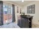 Well-appointed kitchen featuring dark island with seating and access to a private outdoor deck at 17681 E Loyola Dr # E, Aurora, CO 80013