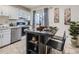 Charming kitchen with white cabinets, modern appliances, and island with bar seating, great for entertaining at 17681 E Loyola Dr # E, Aurora, CO 80013