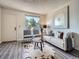 Comfortable living room features contemporary decor, cozy seating, and a sunlit window for natural light at 17681 E Loyola Dr # E, Aurora, CO 80013