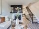 Bright living room boasts modern fireplace, contemporary decor, and beautiful staircase access to upper level at 17681 E Loyola Dr # E, Aurora, CO 80013