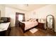 Comfortable bedroom with a large bed and wood flooring at 5732 S Addison Way # E, Aurora, CO 80016