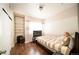 Bright bedroom featuring a striped wall design, wood flooring, and a comfortable twin bed at 5732 S Addison Way # E, Aurora, CO 80016