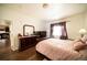 This bedroom is spacious and bright with wood floors, a soft color palette, and a walk-in closet at 5732 S Addison Way # E, Aurora, CO 80016