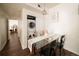 Bright dining area features a modern glass table, contemporary chairs, and convenient laundry closet with a washer and dryer at 5732 S Addison Way # E, Aurora, CO 80016