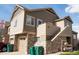 Attractive townhome exterior with attached garage and multiple levels in a landscaped community at 5732 S Addison Way # E, Aurora, CO 80016