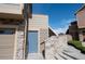 Charming townhome with a blue front door, stone accents, and attached garage at 5732 S Addison Way # E, Aurora, CO 80016