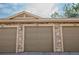 Attached garages offer convenient parking with traditional doors and stone accents on the exterior at 5732 S Addison Way # E, Aurora, CO 80016