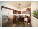 A kitchen showcasing dark wood cabinets and stainless steel appliances at 5732 S Addison Way # E, Aurora, CO 80016