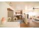 Open-concept living space with a dining table and stainless steel appliances, perfect for modern living and entertaining at 5732 S Addison Way # E, Aurora, CO 80016