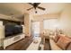 Living room with wood floors, white furniture, and kitchen view at 5732 S Addison Way # E, Aurora, CO 80016