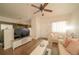 Bright living room with a view of the kitchen with wood floors, white furniture at 5732 S Addison Way # E, Aurora, CO 80016
