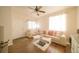 Bright and airy living room with modern furniture, ceiling fan, and natural light at 5732 S Addison Way # E, Aurora, CO 80016