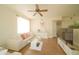 Cozy living room with hardwood floors, neutral walls, comfortable seating, and seamless flow to the dining area at 5732 S Addison Way # E, Aurora, CO 80016