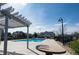 Community pool with a pergola, tables, and lounge chairs, perfect for relaxation and socializing at 5732 S Addison Way # E, Aurora, CO 80016