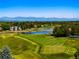 Panoramic view of a lush golf course community with pristine ponds and mountain views at 96 Glenmoor Ln, Cherry Hills Village, CO 80113