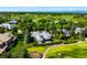 Aerial view of a home with mature trees, manicured grounds and lush green golf course at 96 Glenmoor Ln, Cherry Hills Village, CO 80113