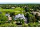 Expansive aerial view showcases the property's prime location on a lush golf course with mature trees at 96 Glenmoor Ln, Cherry Hills Village, CO 80113