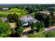 Breathtaking aerial view of estate showcasing lush landscaping, golf course, and sprawling grounds at 96 Glenmoor Ln, Cherry Hills Village, CO 80113