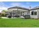 Spacious backyard featuring a covered patio, hot tub, and manicured lawn at 96 Glenmoor Ln, Cherry Hills Village, CO 80113