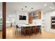 Stylish bar area with modern lighting, sleek countertops, and open layout to the kitchen at 96 Glenmoor Ln, Cherry Hills Village, CO 80113