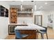 This basement bar features custom cabinets, marble countertops, and pendant lighting at 96 Glenmoor Ln, Cherry Hills Village, CO 80113