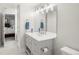 Bright bathroom showcasing a large mirror, vanity with drawers, and view to the primary bedroom at 96 Glenmoor Ln, Cherry Hills Village, CO 80113