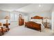 Basement bedroom featuring natural light, a classic dresser, and plush furnishings, creating a cozy space at 96 Glenmoor Ln, Cherry Hills Village, CO 80113