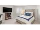 Comfortable bedroom featuring a large bed, built-in shelving, and window with plantation shutters at 96 Glenmoor Ln, Cherry Hills Village, CO 80113