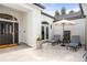 Inviting courtyard featuring tiled flooring, lounge chairs, and an umbrella for a relaxing outdoor experience at 96 Glenmoor Ln, Cherry Hills Village, CO 80113
