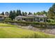 Beautiful home backing onto a golf course, featuring a well-manicured lawn and mature landscaping at 96 Glenmoor Ln, Cherry Hills Village, CO 80113