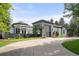 Elegant home with a circular driveway, gray stone portico, and manicured landscaping at 96 Glenmoor Ln, Cherry Hills Village, CO 80113