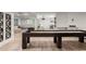 Basement rec room featuring a shuffleboard table, home theater setup, and entertainment amenities at 96 Glenmoor Ln, Cherry Hills Village, CO 80113