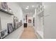 Well-lit hallway features hardwood floors, custom storage, and unique artwork at 96 Glenmoor Ln, Cherry Hills Village, CO 80113